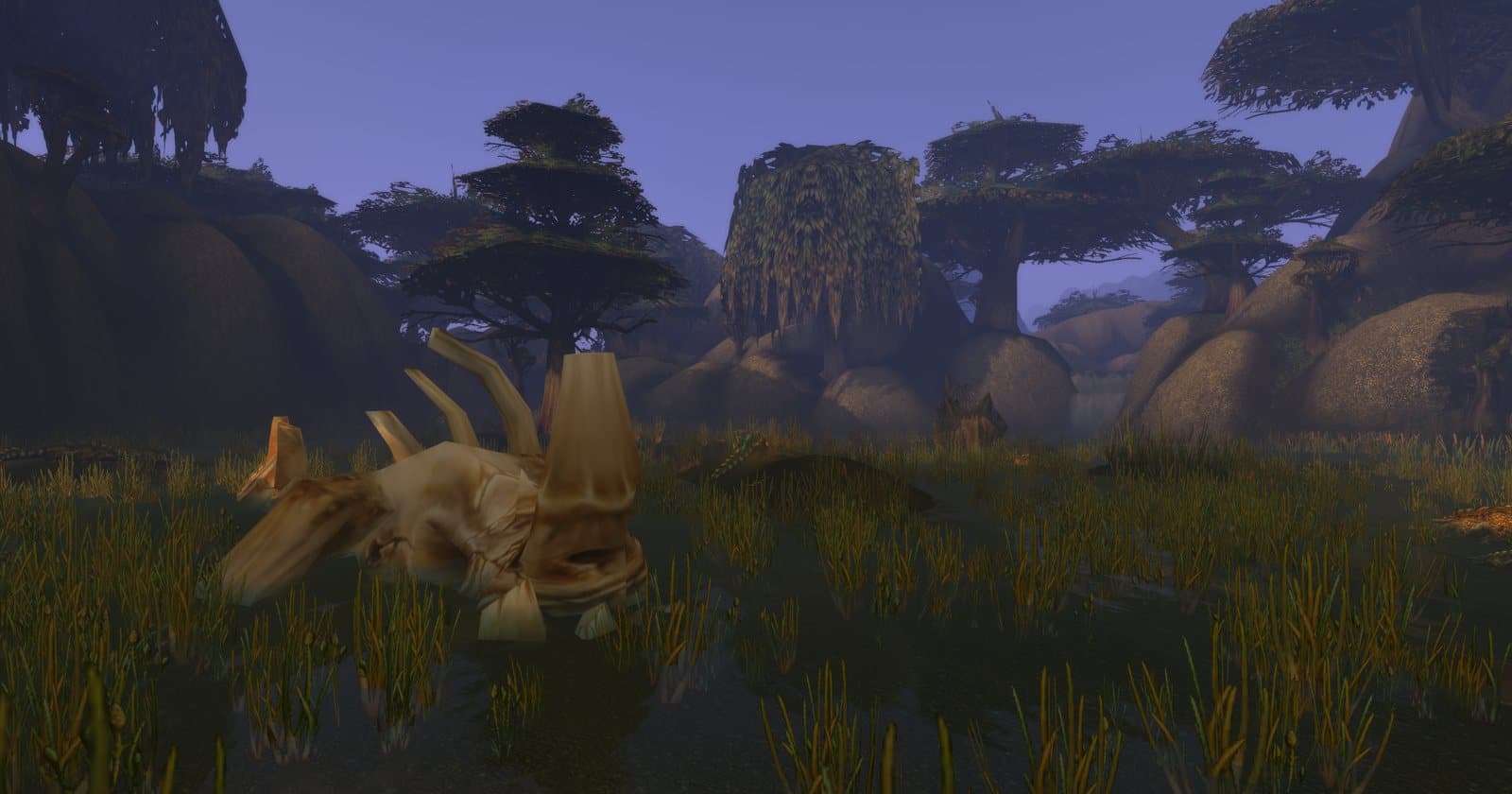 A marsh at dusk with tall reeds, a large bleached skeleton half sunk in the water and broad trees on rocky hills behind